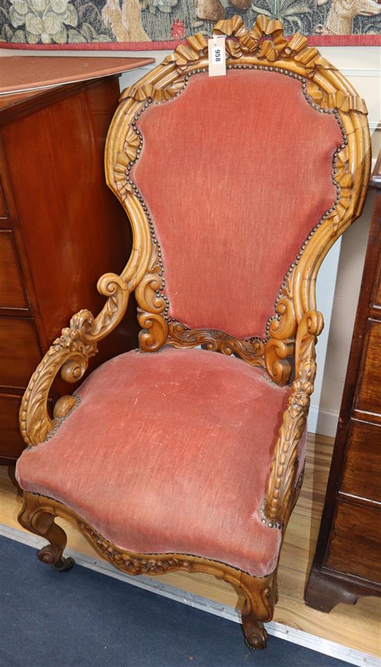 A 19th century French carved walnut showback elbow chair